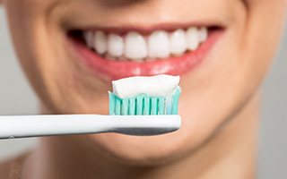 Smile and toothbrush with toothpaste