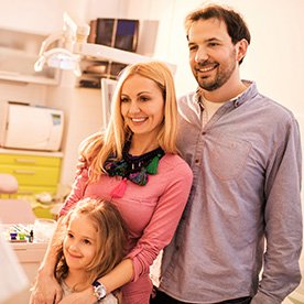 Mother father and daughter at dental office