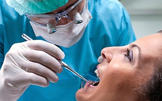 Woman receiving oral cancer screening