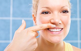 Woman looking at her smile in mirror