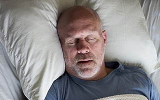 Man sleeping soundly in bed