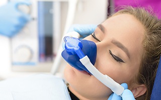 Woman in dental chair with nitrous oxide mask